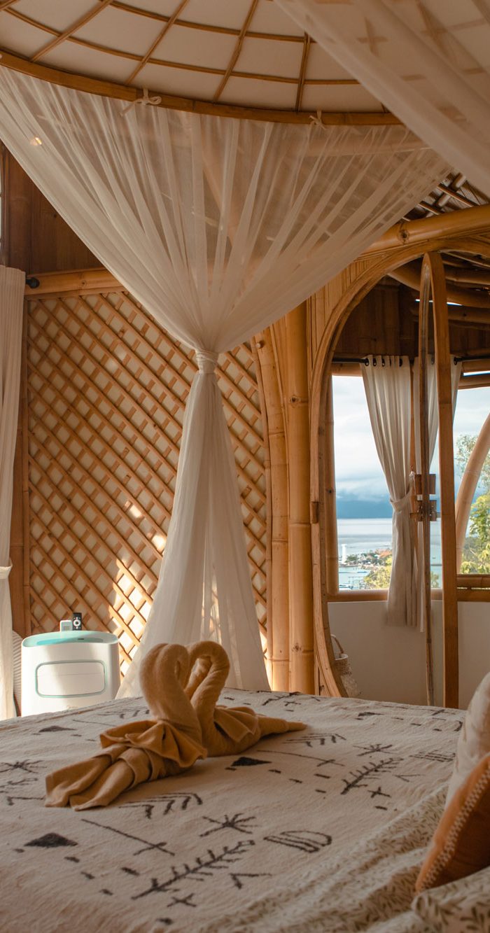 Romantic bamboo Villa bedroom with canopy bed and ocean view at Camanta Penida